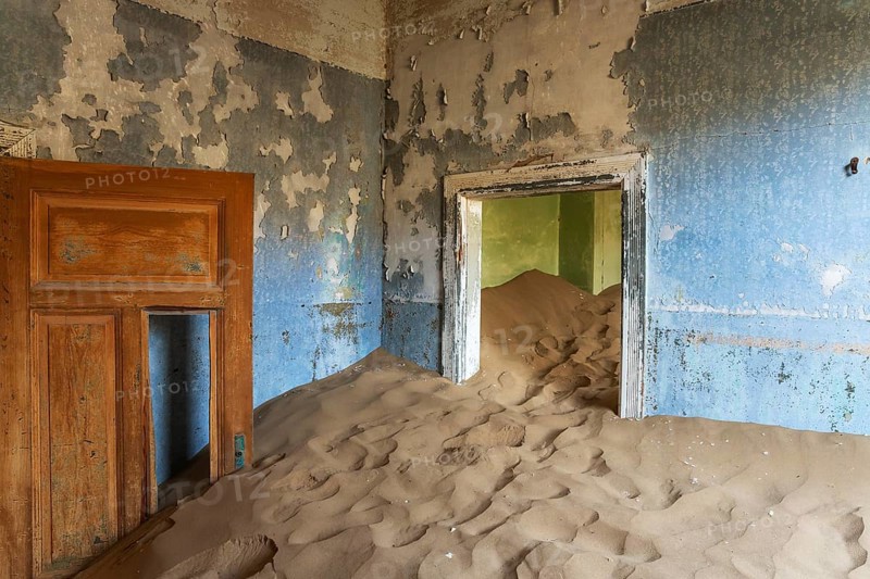 At Kolmanskop, the abandoned ghost town of the diamond days of the early 1900 and of German origin. Inside the restricted Diamond Area east of the coastal town of Lüderitz. Namib Desert, Namibia