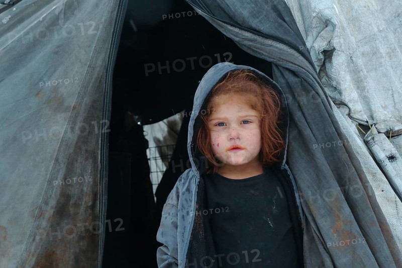 Displaced Syrian families and children living in refugee camps during harsh winter conditions, facing snow, cold weather, and difficult humanitarian circumstances. Aleppo, Syria January 01, 2022, Aleppo, Syria