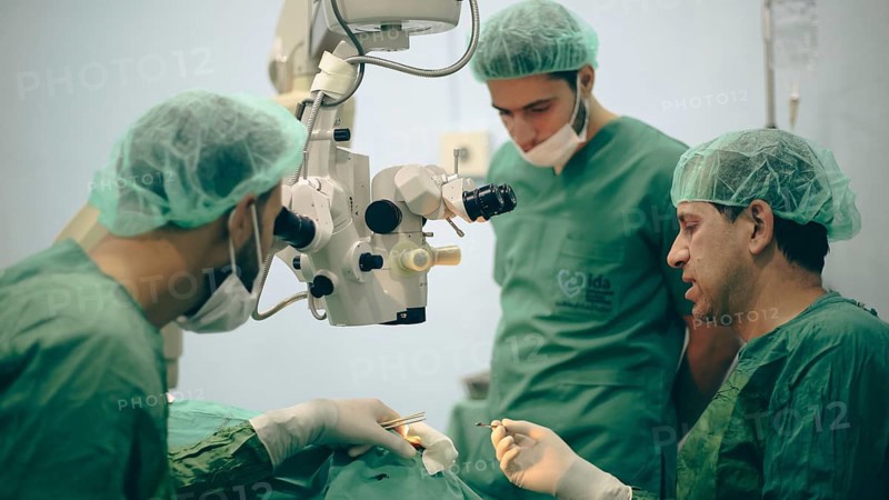 Several doctors performing a complex surgical operation inside an operating room for a displaced patient. Aleppo, Syria. October 18, 2022, Aleppo, Syria