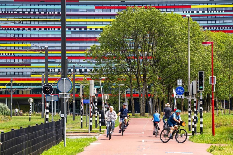Cycle path through the university campus in Utrecht Science Park, Utrecht University, colourful facade of the Hogeschool Utrecht building, Netherlands