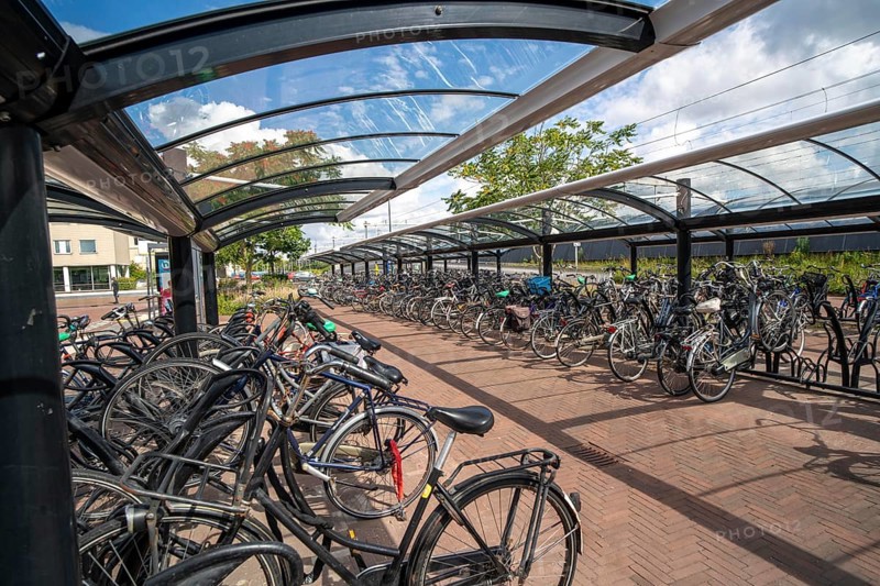 Bicycle parking spaces and boxes on the cycle path in the east of Utrecht, at Utrecht-Lunetten railway station, direct connection of the cycle path to the railway station and bus station, covered bicycle stands, on the Maarschalkerweerdpads cycle path, Netherlands