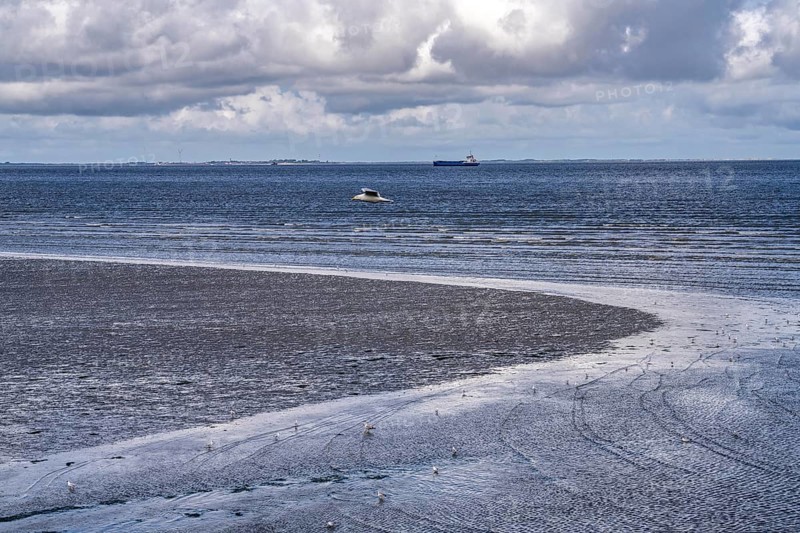 Wadden Sea between the Dutch coast near Eemshaven and the German North Sea island of Borkum, Wadden Sea National Park, UNESCO World Heritage Site, low tide, low water, clouds