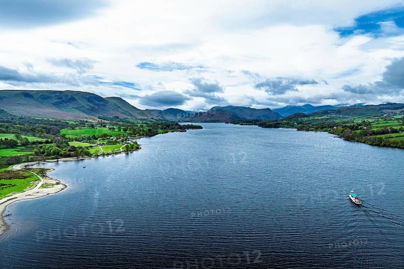 Farms and mountains over Ullswater Lake from drone, Pooley Bridge, Lake District National Park, Cumbria, England, United Kingdom