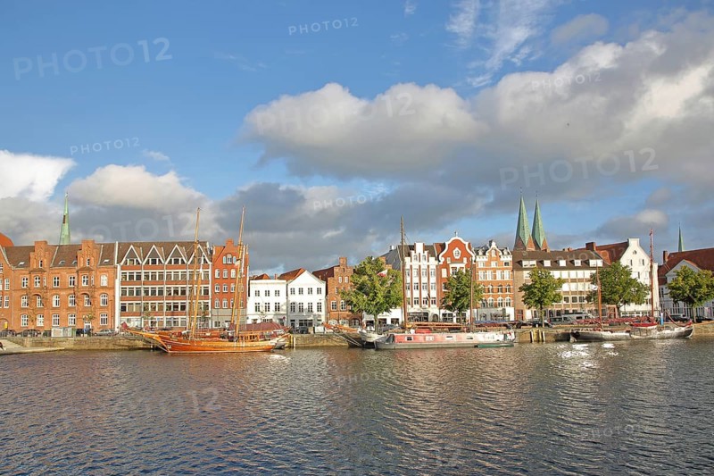 Ships on the banks of the Stadttrave, houses, cityscape, sailing ship, harbour, steeples of St. Mary's Church, light mood, old town, Lübeck, Schleswig-Holstein, Germany
