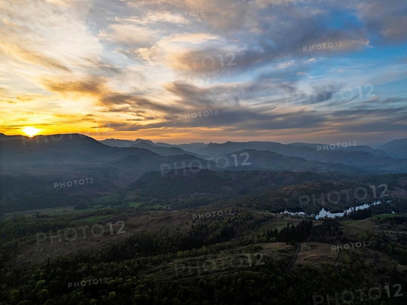 Sunset over Mountains and Coniston Water from drone, Lake District National Park, Cumbria, England, United Kingdom