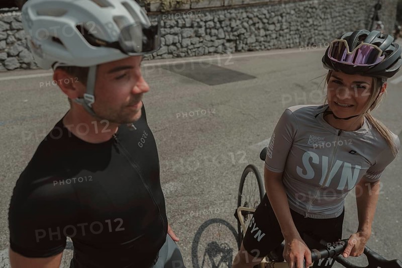 Woman and man cycling on Lake Garda in Italy. Sunny weather and dolce vita