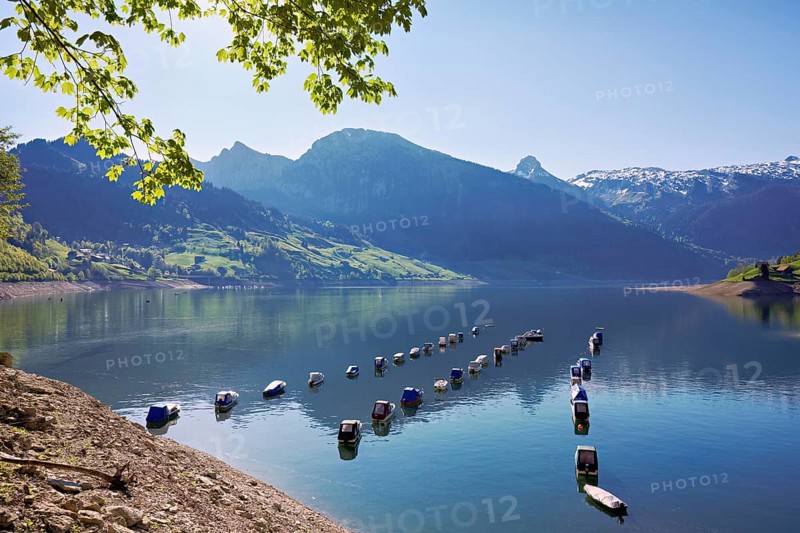 Motorboats moored at the reservoir, snow-covered Alps in the background, Lake Wägital, Canton Schwyz, Switzerland