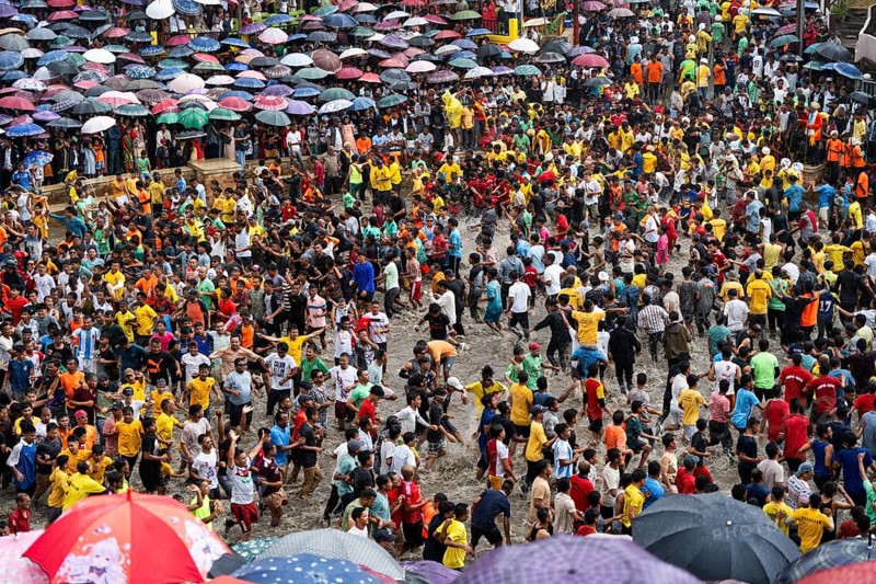 People from the Pnar community march in a circle as they celebrate an event organized to mark the Behdienkhlam festival in Jowai, India on July 14, 2025. Behdienkhlam is a vibrant annual festival celebrated by the Pnar (Jaintia) community of Meghalaya, especially in Jowai, to drive away plague and diseases and to pray for a good harvest. Observed in July after the sowing season, it features traditional rituals, offerings to ancestral spirits, and the grand procession of beautifully decorated bamboo structures called rots, which are later immersed in a sacred muddy pool known as Ka Aitnar