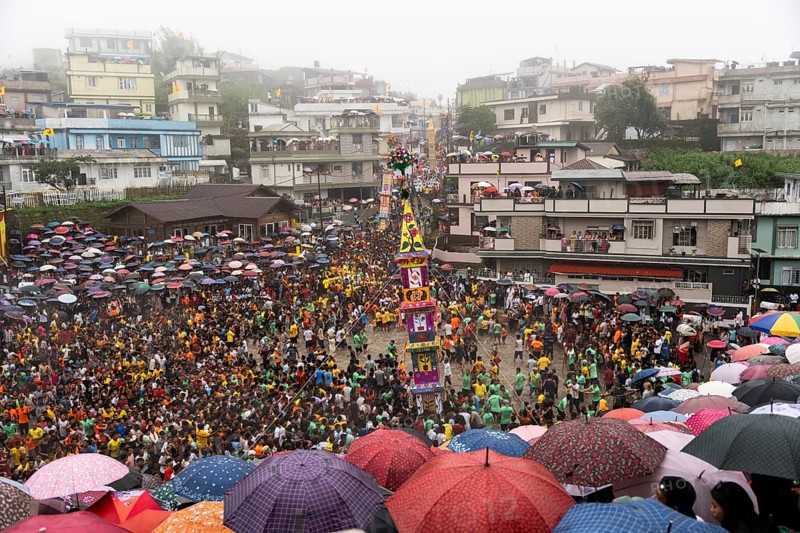 People from the Pnar community march in a circle around a Rot as they celebrate an event organised to mark the Behdienkhlam festival in Jowai, India on July 14, 2025. Behdienkhlam is a vibrant annual festival celebrated by the Pnar (Jaintia) community of Meghalaya, especially in Jowai, to drive away plague and diseases and to pray for a good harvest. Observed in July after the sowing season, it features traditional rituals, offerings to ancestral spirits, and the grand procession of beautifully decorated bamboo structures called rots, which are later immersed in a sacred muddy pool known as Ka Aitnar