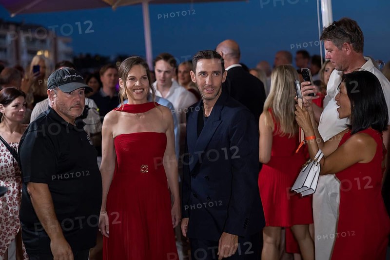 Hilary Swank and Marcel Remus walk through the crowd at the Remus Lifestyle Night on the rooftop terrace of the Pure Salt Hotel in El Toro, Magaluf, Majorca, Spain on 31/07/2025
