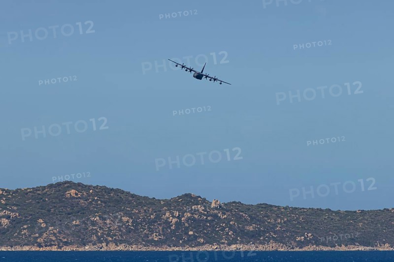 A Lockheed Martin MC-130J Commando II, a US Air Force military aircraft, flies low over Costa Rei, a coastal area of the Italian Mediterranean island of Sardinia, Monte Nai, Costa Rei, Sardinia, Italy