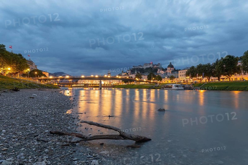 The city of Salzburg with the Salzach shines in the first light of summer morning