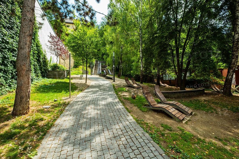 Small park with seating, a playground and a fountain at the entrance to Trencin Castle, Capital of Culture 2026, Trencín, Slovakia