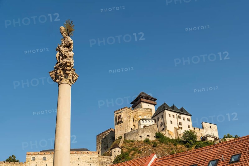 Plague column commemorating the victims of the plague column at the beginning of the 18th century, in the background is Trencín Castle, Capital of Culture 2026, Trencín, Slovakia