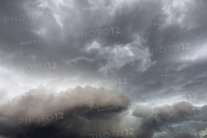 Below dark discoloured storm clouds Cloud roll above grey clouds Rain clouds heralding thunderstorms, Germany