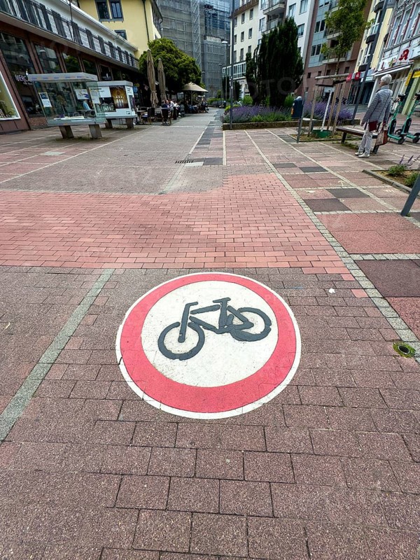 Official traffic sign painted on cobblestones in pedestrian zone Use of passage forbidden for bicycles, Aachen, North Rhine-Westphalia, Germany