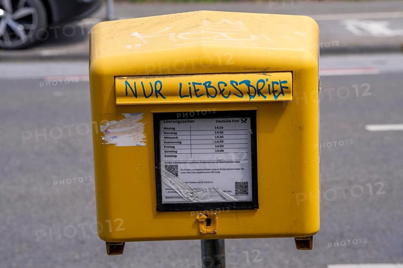 Deutsche Post letterbox, with stickers and graffiti, labelled Only love letters, Leverkusen, North Rhine-Westphalia, Germany