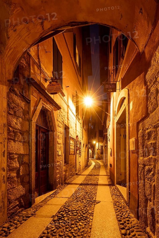 Alley illuminated at night, old town centre, Orta San Giulio, on Lake Orta, Province of Novara, Piedmont, Italy