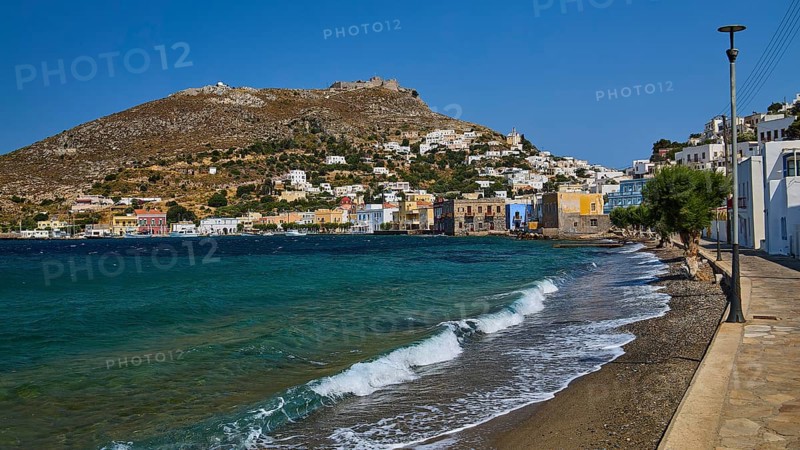 Panteli Fortress, seafront promenade of a coastal town with waves and beautiful hills, Agia Marina, Leros, Dodecanese, Greek Islands, Greece
