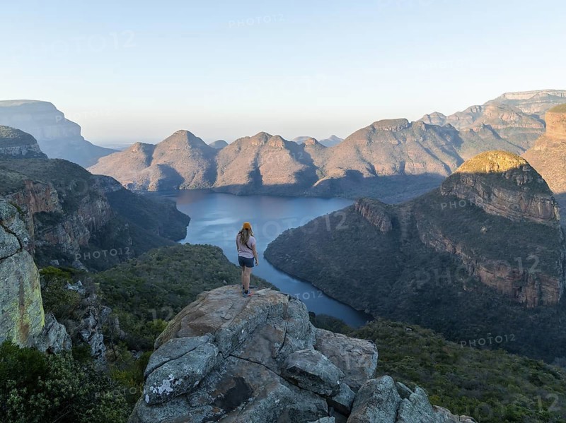 Hiker enjoying panorama, Blyde River Canyon with summit Three Rondawels, view of canyon with river Blyde River and table mountains, canyon landscape, Panorama Route, Mpumalanga, South Africa