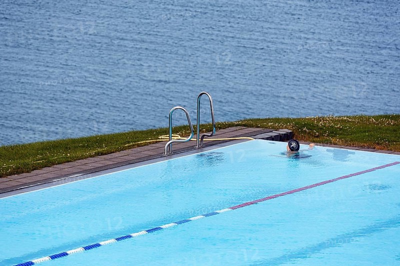 View from above of swimming pool by the sea, thermal bath, heated outdoor pool in Hofsos at the fjord Skagafjördur, Lake Greenland, Hofsos, Tröllaskagi peninsula, Nordurland vestra, North Iceland, Iceland