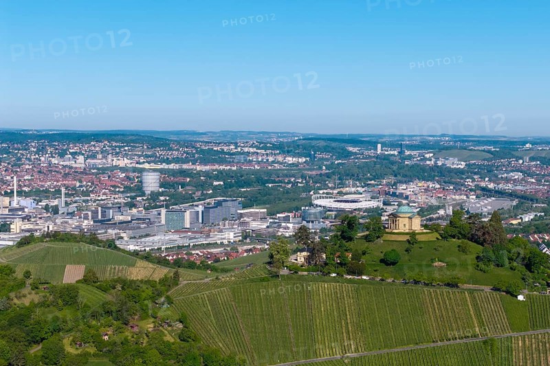 Vineyards and green hill with a building, city panorama in the background, view of the burial chapel of Stuttgart-Rotenberg, in the background the Mercedes-Benz plant in Stuttgart-Untertürkheim and the MHP Arena, Baden-Württemberg, Germany