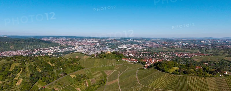 Panoramic view over extensive vineyards with a town and industry in the background, view of Rotenberg near Stuttgart with a burial chapel, in the background the Mercedes -Benz plant in Stuttgart-Untertürkheim and the MHP Arena, Baden-Württemberg, Germany