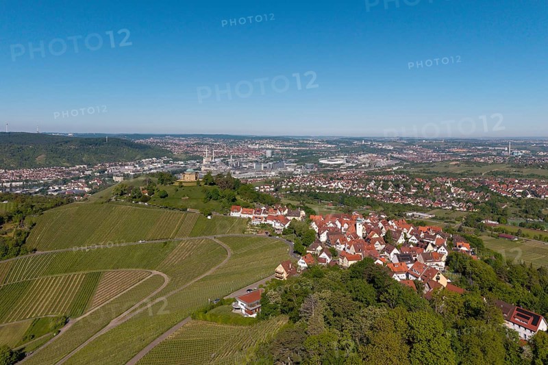 Panorama of a town with vineyards and red roofs under a clear sky, view of Rotenberg near Stuttgart with a burial chapel, in the background the Mercedes-Benz plant in Stuttgart-Untertürkheim and the MHP Arena, Baden-Württemberg, Germany