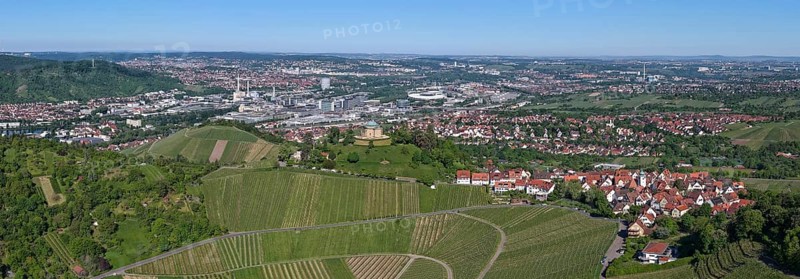 Panoramic view of a town with surrounding vineyards and a clear sky, view of Rotenberg near Stuttgart with a burial chapel, in the background the Mercedes-Benz plant in Stuttgart-Untertürkheim and the MHP Arena, Baden-Württemberg, Germany