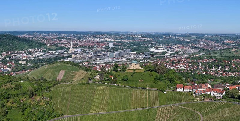 View of a cityscape with vineyards and hills under a blue sky, view of Rotenberg near Stuttgart with burial chapel, in the background the Mercedes-Benz plant in Stuttgart-Untertürkheim and the MHP Arena, Baden-Württemberg, Germany