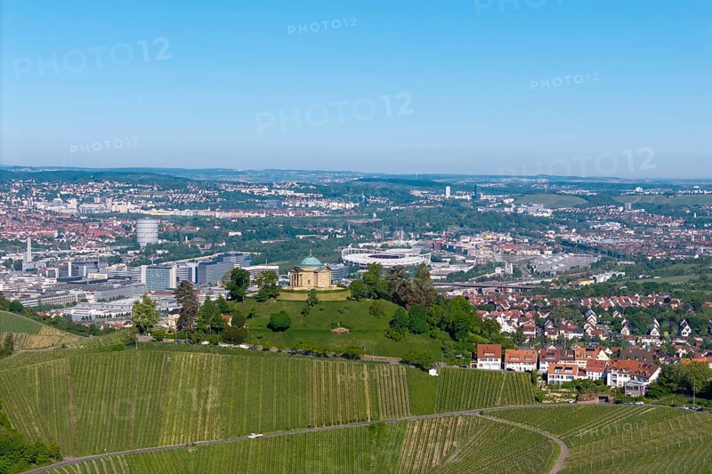 View of a building on a hill in front of a wide cityscape and vineyards, view of Rotenberg near Stuttgart with burial chapel, in the background the Mercedes-Benz plant in Stuttgart-Untertürkheim and the MHP Arena, Baden-Württemberg, Germany