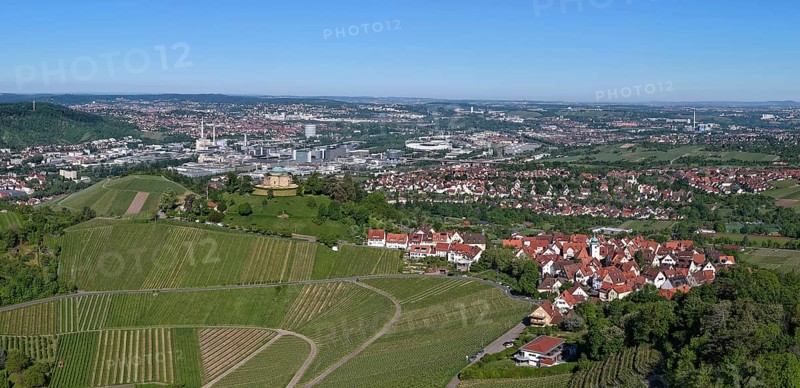 Panoramic view of a town with surrounding vineyards under a clear blue sky, view of Rotenberg near Stuttgart with a burial chapel, in the background the Mercedes-Benz plant in Stuttgart-Untertürkheim and the MHP Arena, Baden-Württemberg, Germany