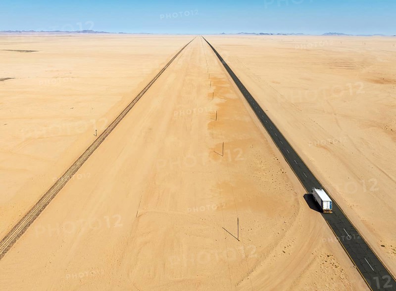 Rails and the B4 tarred road between Aus and Lüderitz in the southern Namib Desert. Aerial view. Drone shot. Namibia