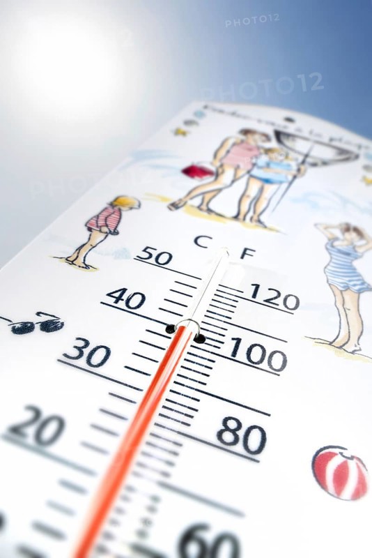 Worm's-eye view of thermometer measures extremely hot temperature of 40 degrees Celsius, 40 °C, 100 °F during heatwave, heat wave in summer