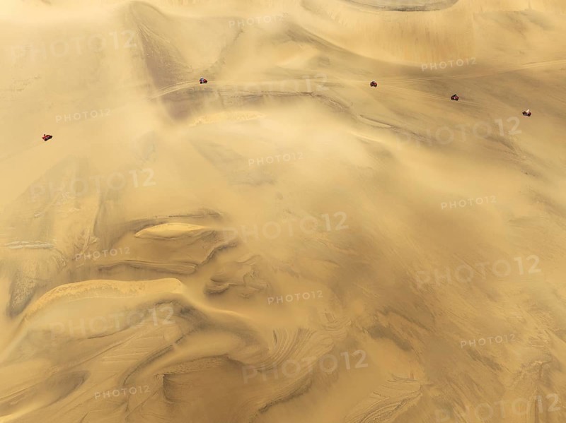 Quad bikes in the dunes of the Namib Desert in the vicinity of the coastal town of Swakopmund. Aerial view. Drone shot. Namibia