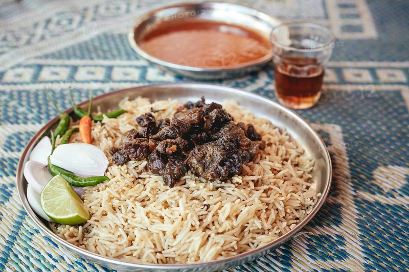 Traditional camel restaurant in Salalah, dry braised camel meat on rice, Dhofar, Oman