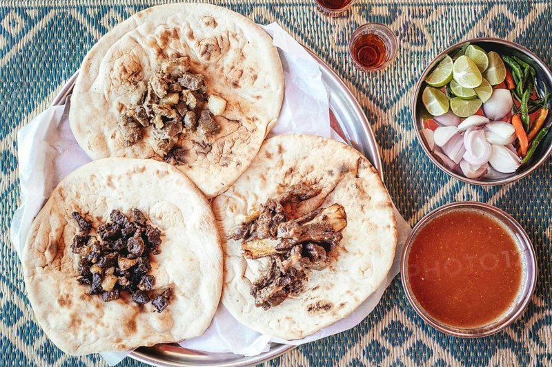 Traditional camel restaurant in Salalah, three kinds of camel meat (dry braised, boiled and grilled/baked), traditionally served with bread and chutney, Dhofar, Oman