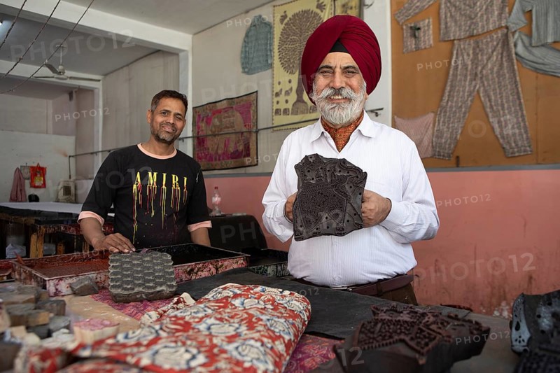 Indian men showing wooden panels for woodblock printing, Jaipur, Rajasthan, India