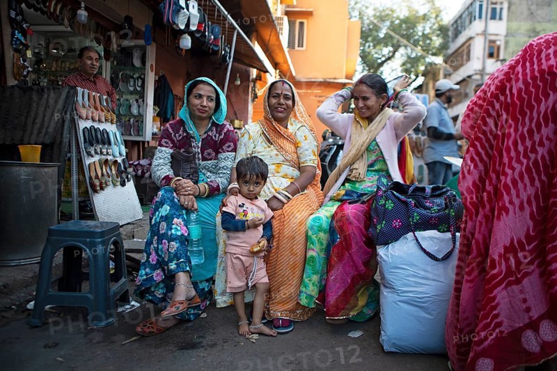 Indian child and Indian woman in colourful saris laughing out of focus in the old town, Jaipur, Rajasthan, India