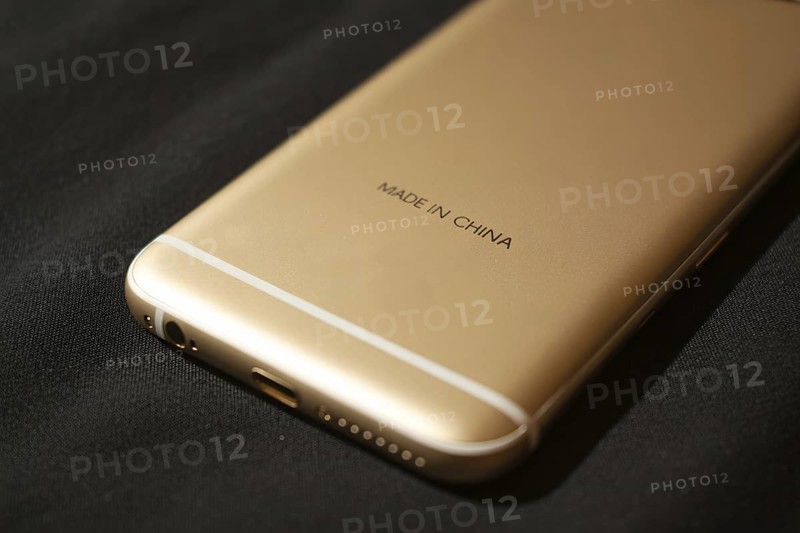 Back of golden smartphone with text Made in China. Concept of globalization and offshore manufacturing. Generative ai, AI generated
