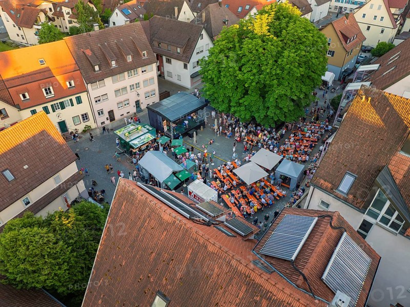 Aerial view of a lively town festival, surrounded by orange-coloured roofs and green trees in summer, 950th anniversary of Weil der Stadt, Böblingen district, Germany