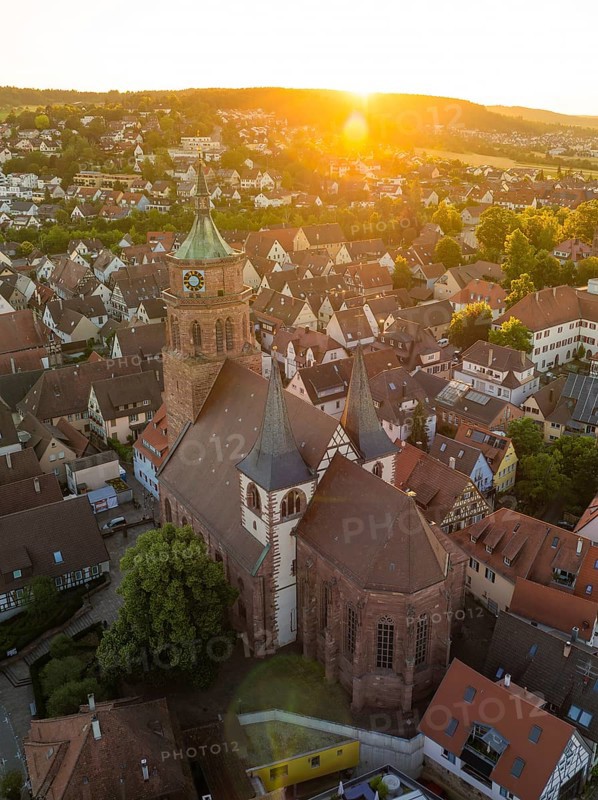 Picturesque view of a church and town at sunset with historical buildings and roof landscapes, 950 years Weil der Stadt ceremony, Böblingen district, Germany