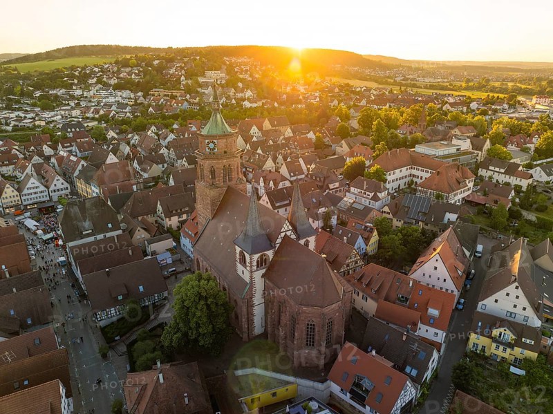 Aerial view of a church surrounded by an idyllic cityscape at sunset, 950 years Weil der Stadt ceremony, Böblingen district, Germany