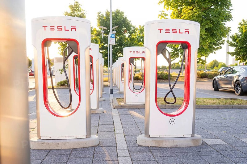 Tesla charging stations in a sunny environment with green trees in the background, Tesla Supercharger Böblingen, Germany