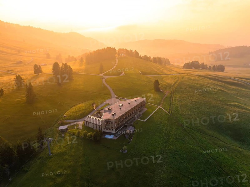 Architectural building on a hill with evening light and peaceful atmosphere, Alpe di Siusi, Dolomites, South Tyrol, Italy