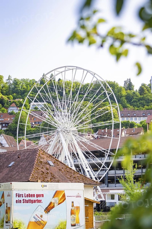 White Ferris wheel with buildings and advertising in the foreground, Ferris wheel construction for the 950th anniversary of the town of Calw, Black Forest, Germany