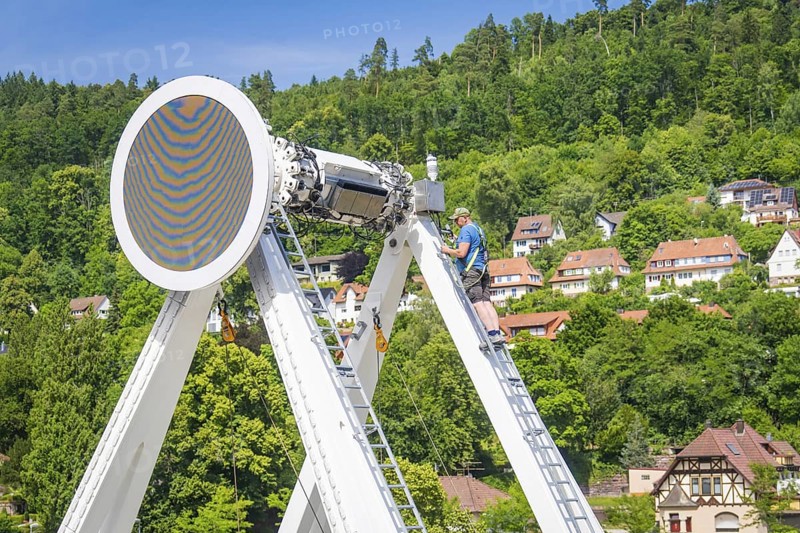 Workers on ladders building a Ferris wheel with a view of a village in the background, Ferris wheel construction for the 950th anniversary of the town of Calw, Black Forest, Germany