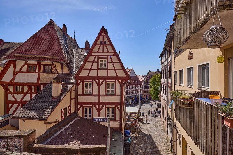 Historic half-timbered houses, residential buildings, gables, pointed roofs, façade, window, balcony, backlight, blue sky, cirrostratus clouds, Am Ölberg, Beim Tiergärtnertor, Obere Schmiedgasse, Nuremberg, Middle Franconia, independent city, Bavaria, Germany