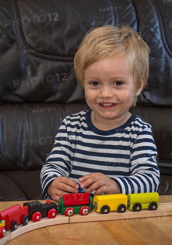 JBlond boy, 2 years old, playing with toy train in Ystad, Skåne County, Sweden, Scandinavia