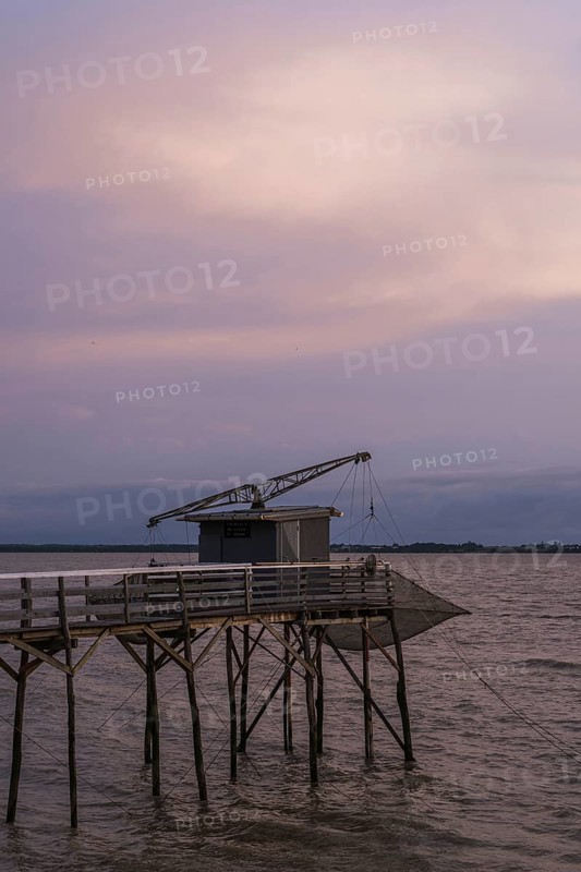 Sunset over Fishing huts over Gironde Estuary, Braud-et-Saint-Louis, France